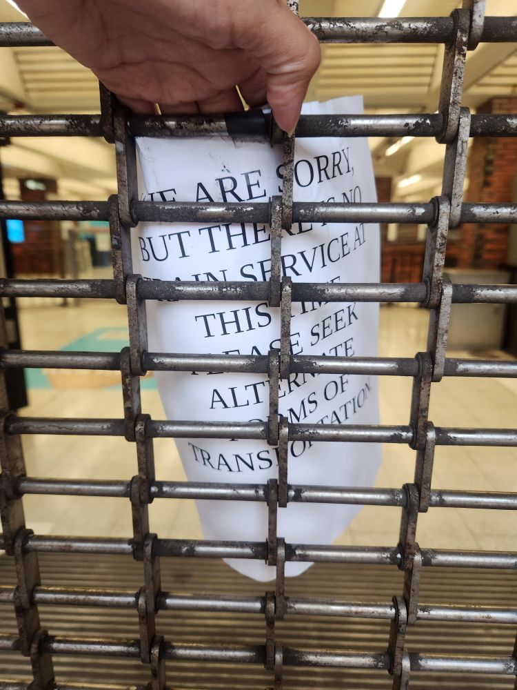 Sign reads we are sorry but there's  no train service at this time. Please seek alternative forms of transportation.