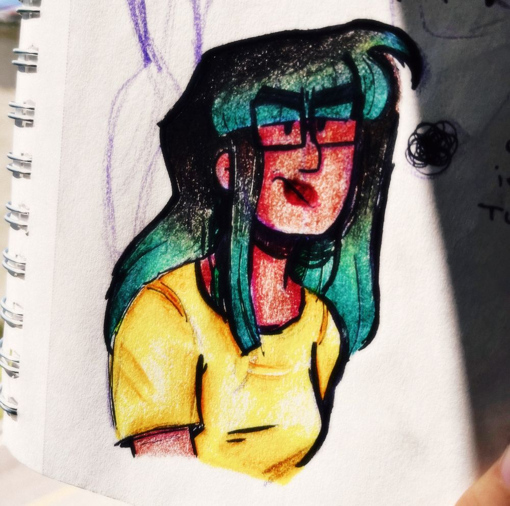 A hook-nosed brown girl with thick-rimmed square glasses in a yellow t-shirt. She has long, straight, dark brown-black hair fading into a blue-green hue. She looks slightly irritable.