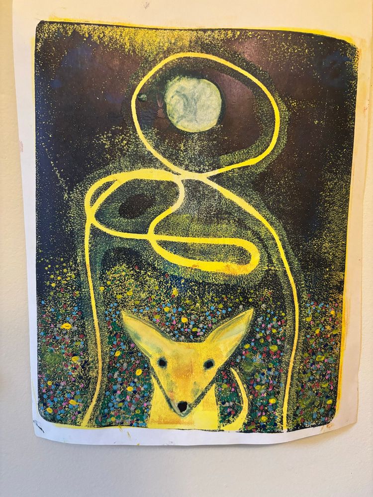 A gel monoprint of a small dog under a full moon. A field of wildflowers surround the dog. Colours are mostly yellow, blues and black. 