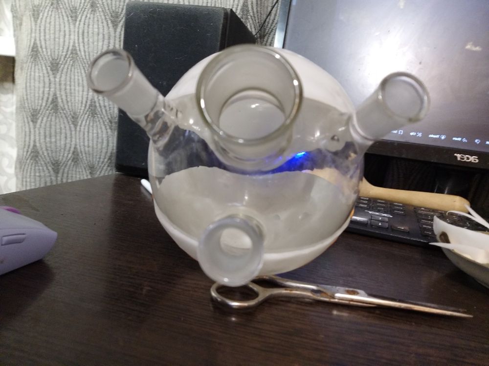 A glass sphere with two sheets of plastic wrapped around it as two hemispheres.