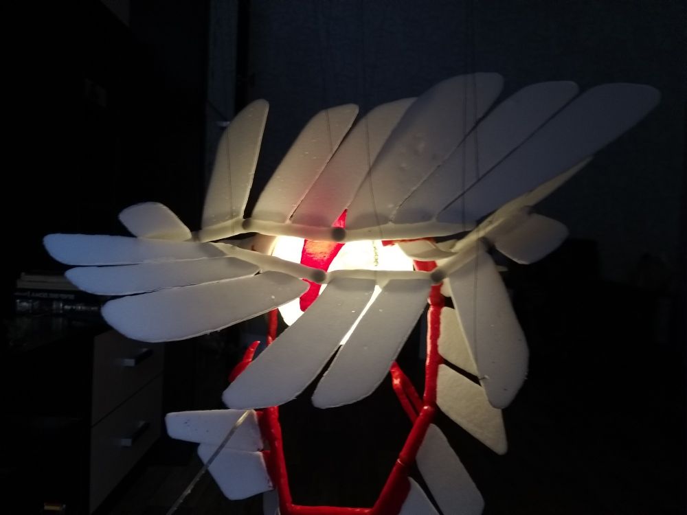 A plastic owl hiding in its feathers.