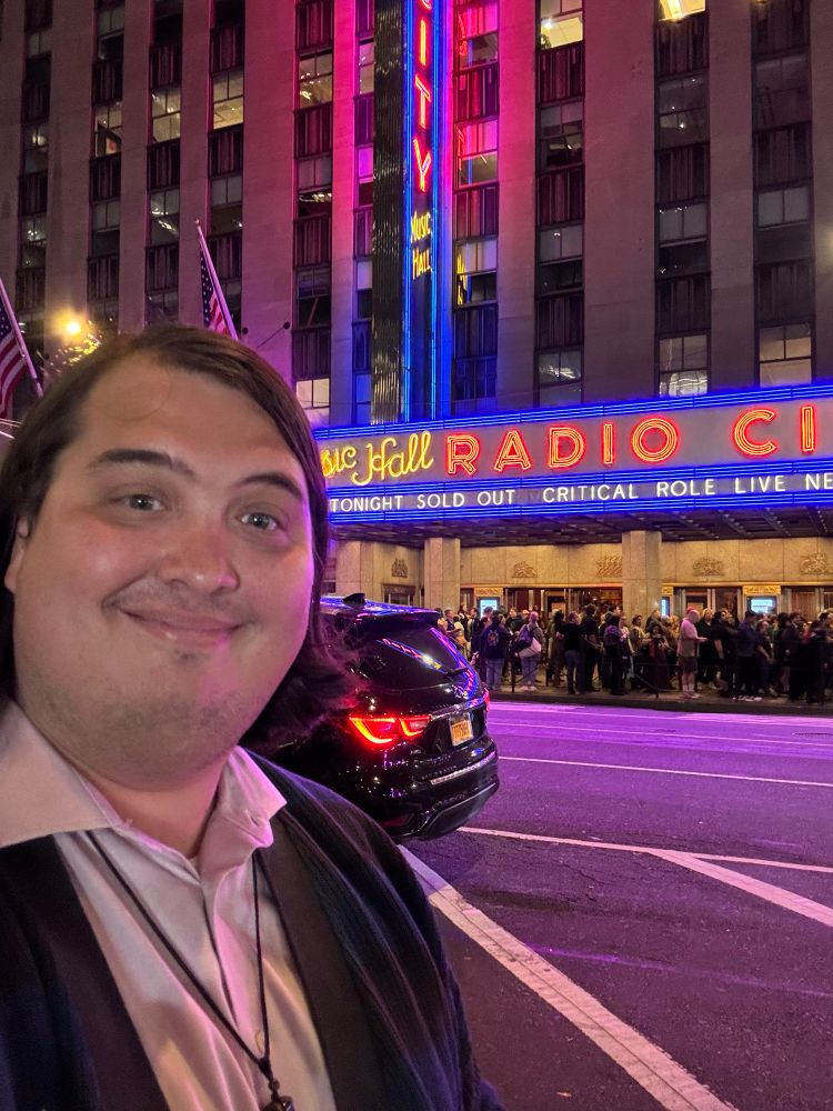 Griffin standing in front of radio city music hall with Critical Role marquis