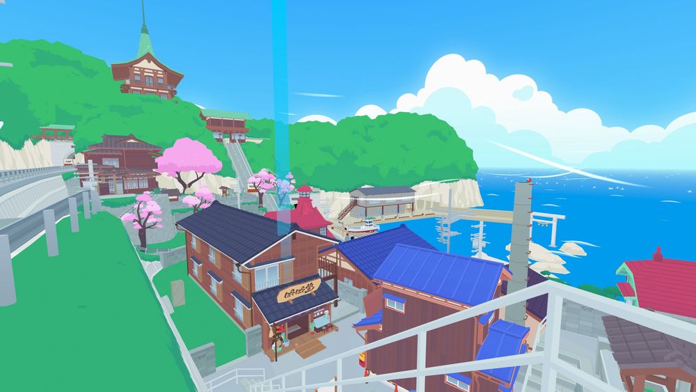 Kotobuki Town as seen from the upper road. Verdant tree canopies cover the overlooking hills with a shrine poking through, a gate and stairs beside it leading down to sakura trees. The town is very small and rustic with a smattering of small wooden buildings with colourful rooftops. A torii gate leads to the sapphire sea with shining white clouds on the horizon.