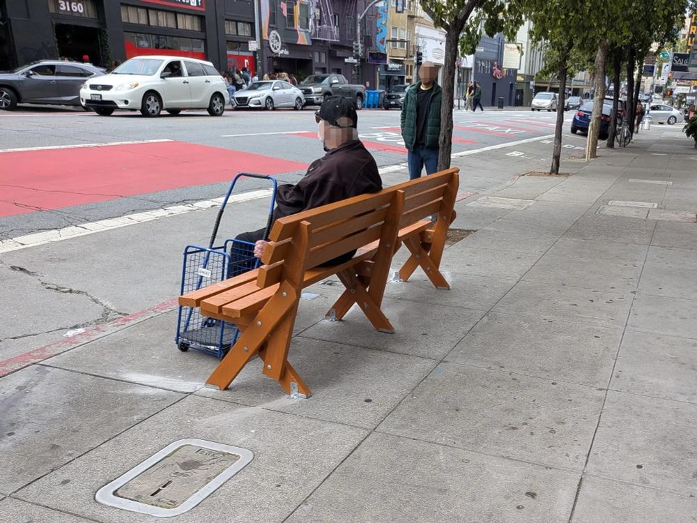a senior sitting on a bench waiting for a bus at Mission/Powers