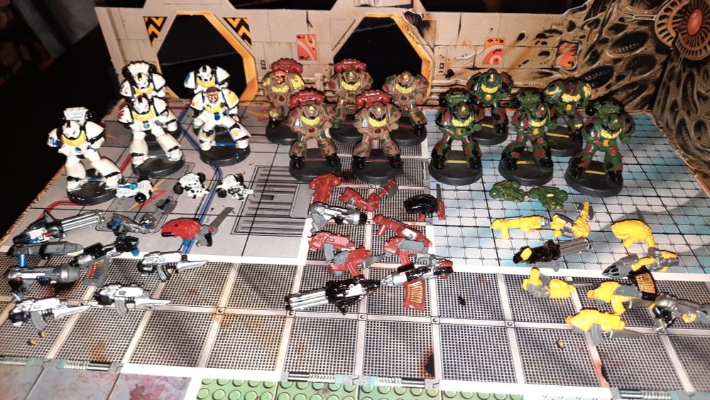 Painted Space Marines Miniatures from the StarQuest Boardgame with all their weapon options before them. 