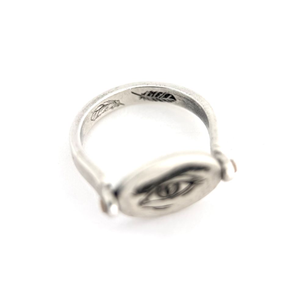 The inside of the band is engraved with two feathers, one white and one black.