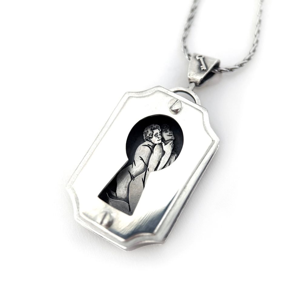A sterling silver shadowbox pendant shaped like a rectangular keyhole escutcheon. Through the keyhole cutout in the front, you can see Aziraphale and Crowley having sex.  They are both kneeling; Aziraphale is behind Crowley and is leaning in with his chin resting on Crowley’s shoulder, wearing a tender expression. He has his right arm wrapped around him with his hand placed on Crowley’s throat. Crowley is clearly enjoying himself very much with his back arched, head thrown back, a silly grin, and a tiny - but proportional! - erection.
