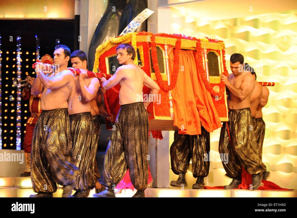 Men carrying palanquin, stage performance, India