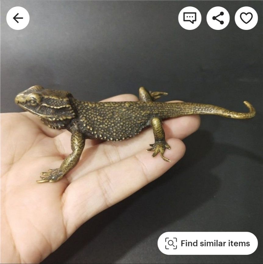 A brass anole, or gecko, or lizard, depending on your relative level of specificity from having lived w them or not