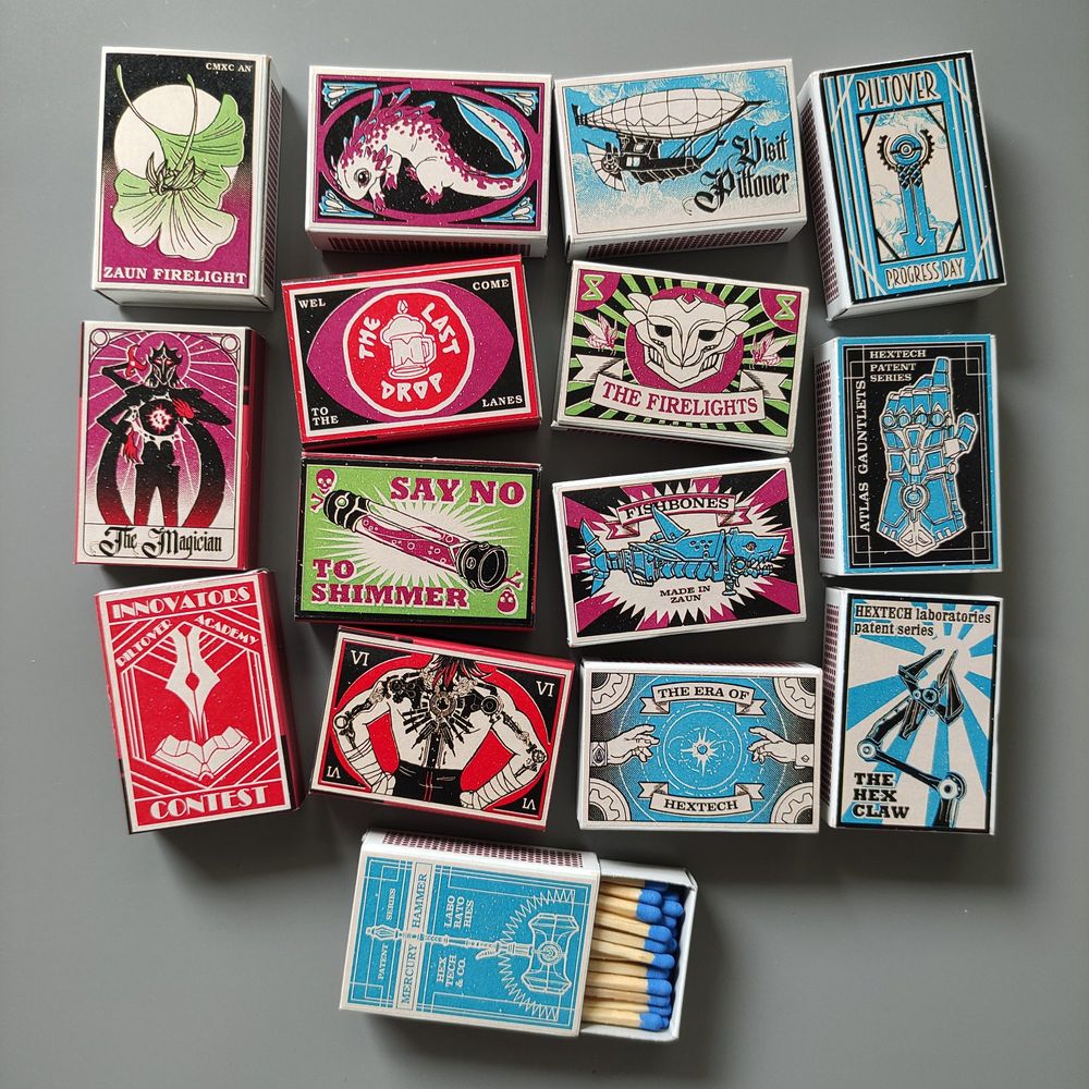 Set of matchboxes with Arcane-themed designs on the labels.