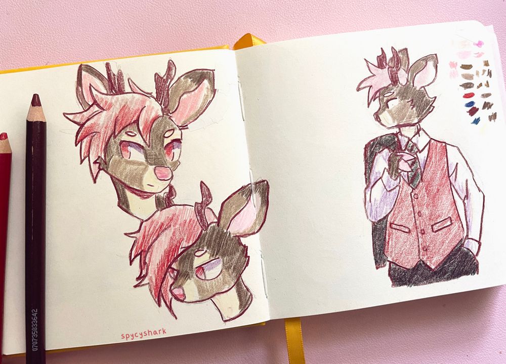 A photo of a sketchbook page. There are three doodles of a deer character in colored pencil. 