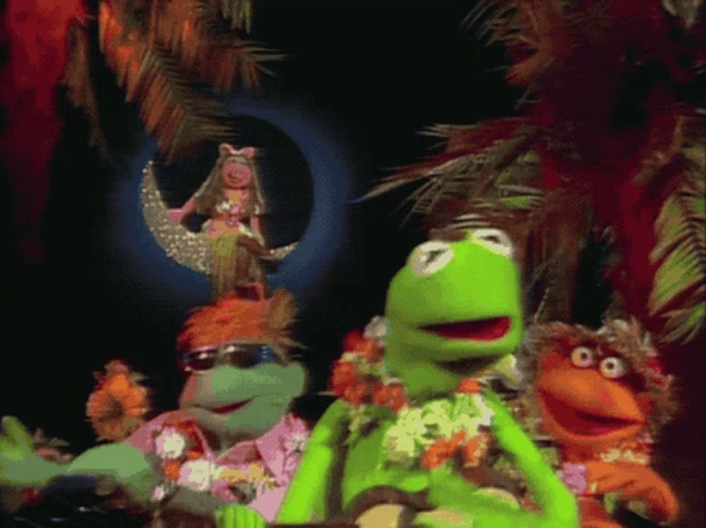 a group of muppets are standing in front of a moon