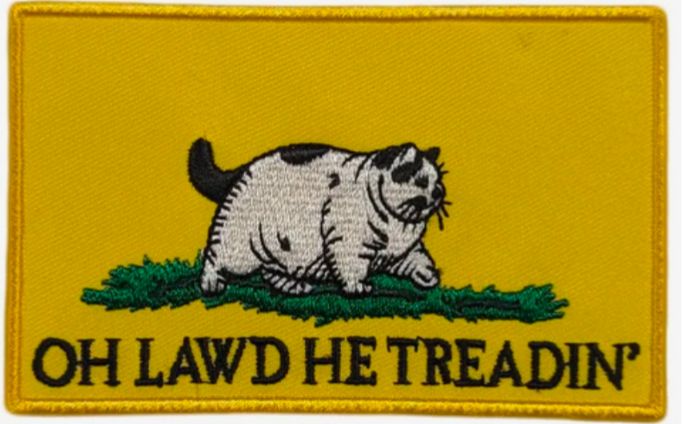 A parody of the Gadsden flag with a chonker of a cat walking on a snake with the words "Oh Lawd He Treadin'"
