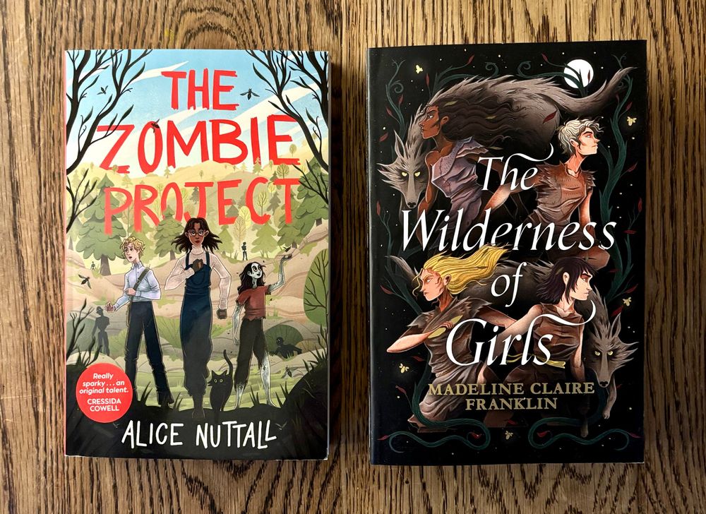 The covers of two new books. The Zombie Project shows two purposeful teenage kids, and a friendly-looking teenage zombie, who's holding her hand out to a bee. The Wilderness of Girls shows four young women and two wolves under a full moon, against a stylised forest background.