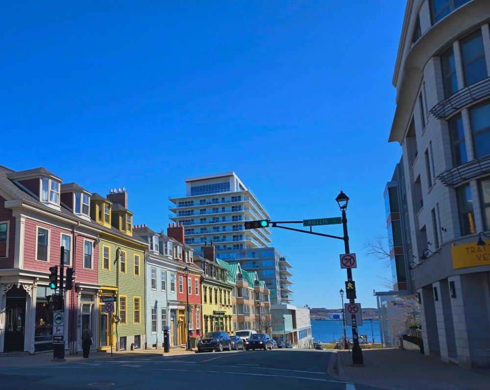Anrow of colorful three storey homes with a tower in the background