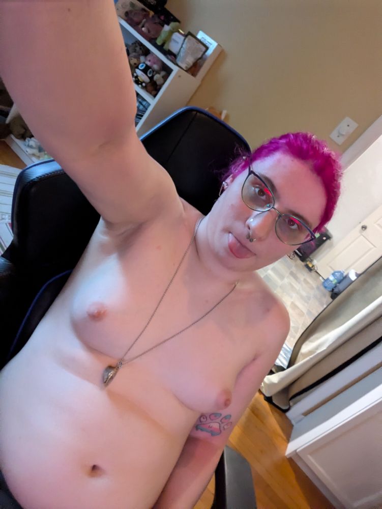Us with our big trans fem tits out with pink hair and a geode necklace on 
