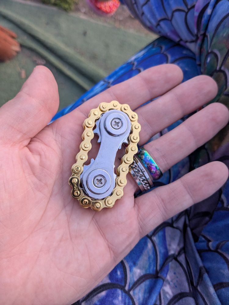 A gold and silver bike chain fidget 
