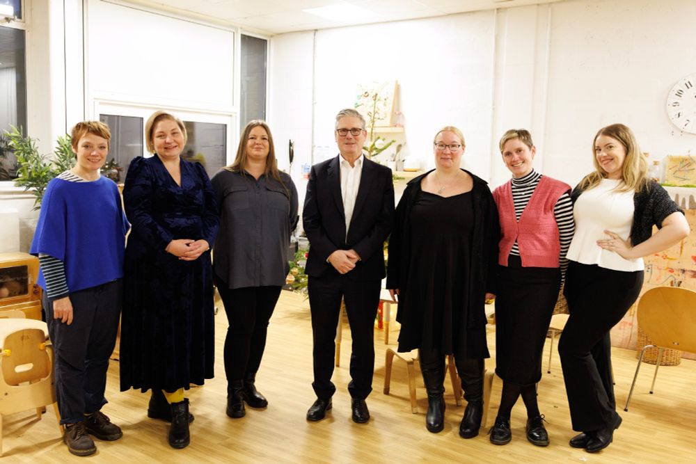 PM Keir Starmer standing with members of the Changing Realities group members.