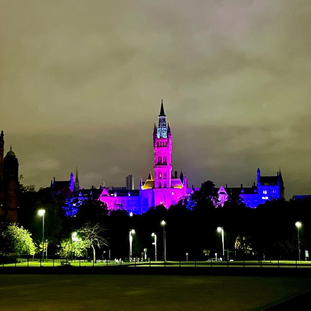 The University of Glasgow Main Building and Tower at night lit blue and pink to mark Baby Loss Awareness Week