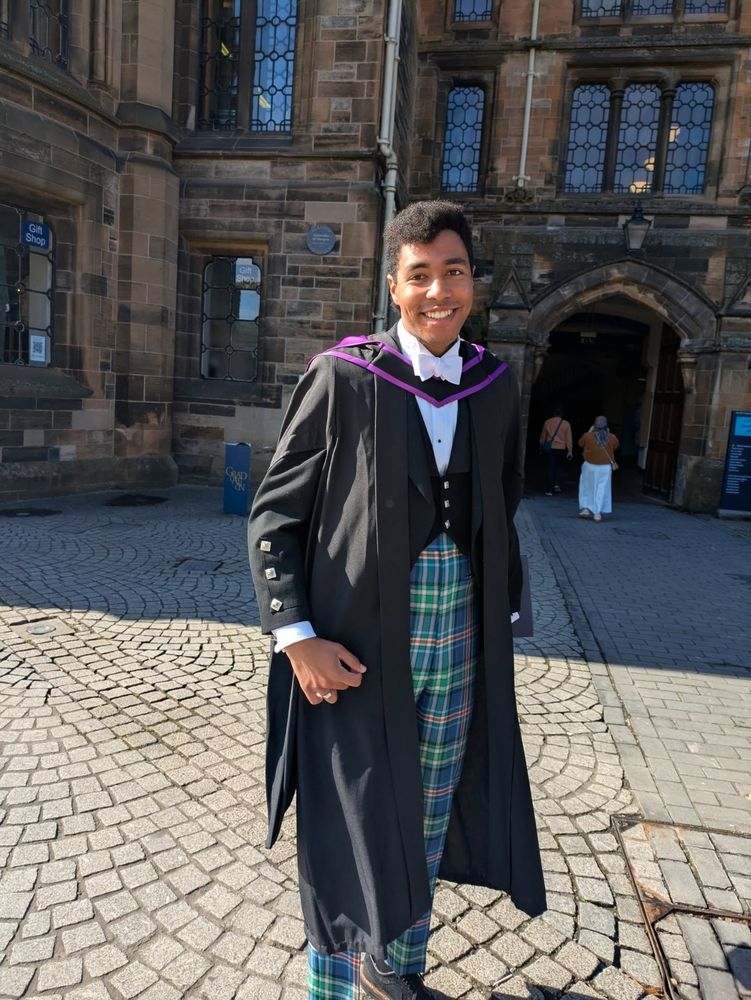 A graduate in tartan trousers.