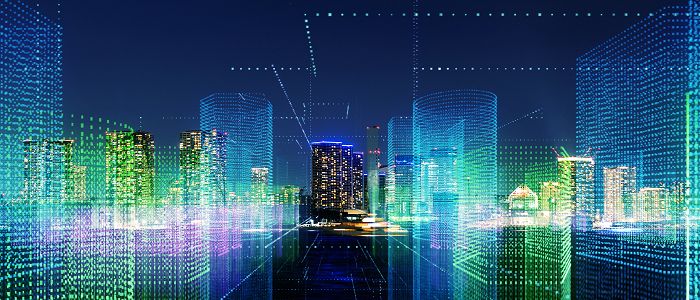 A city skyline at night, with buildings represented by glowing blue and green data lines and grids demonstrating digital urban planning.