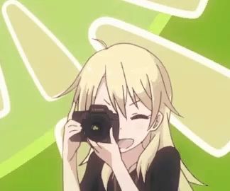 a blonde anime girl is holding a canon camera in front of her face