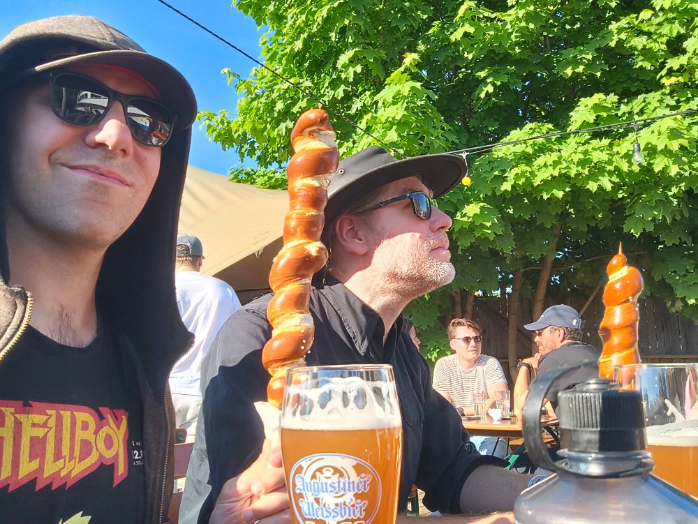 Posing with snarl, holding big Bretzel skewer and having beers