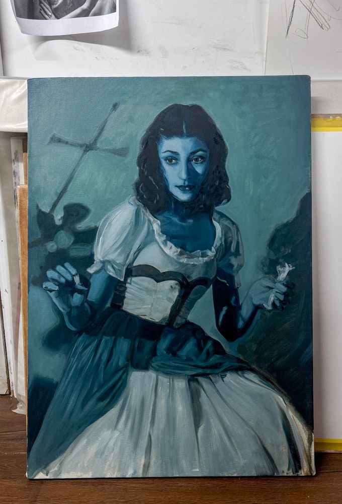 A painting of a woman in a white dress, propped up against a wall