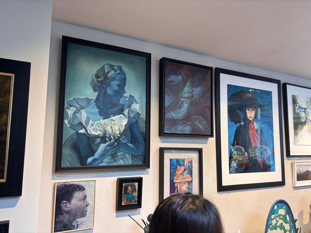A wall with blueish pictures.