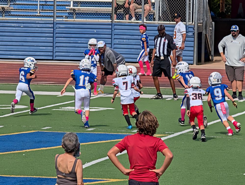 Pee wee football game between a team in blue and a team in red and white. My nephew is #7 in red and white.