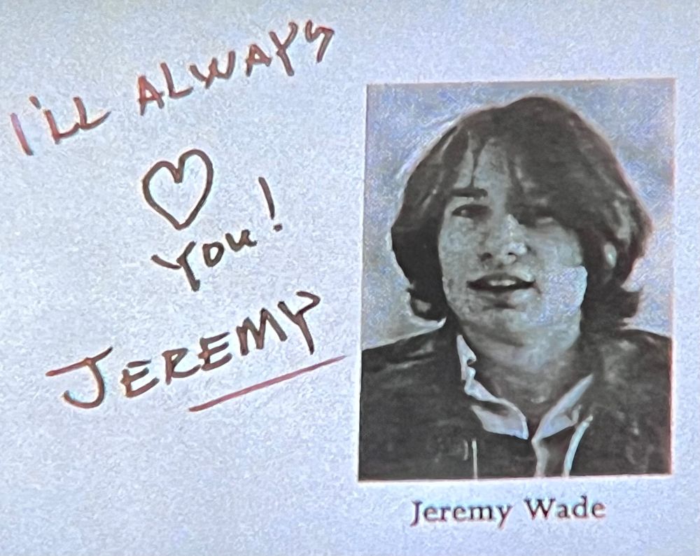 A high-school yearbook photo of a young man with long hair