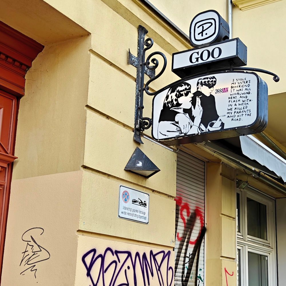 The picture and text from Sonic Youth's  Goo on a sign outside a yellow house