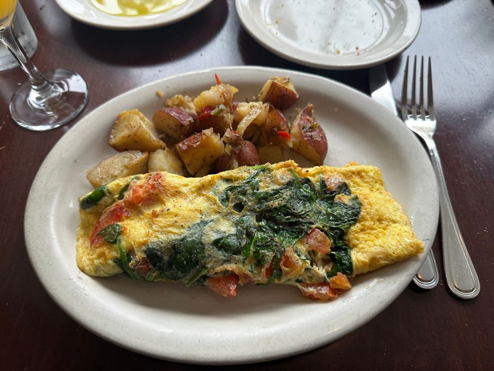 A feta and spinach omelette and potatoes. 