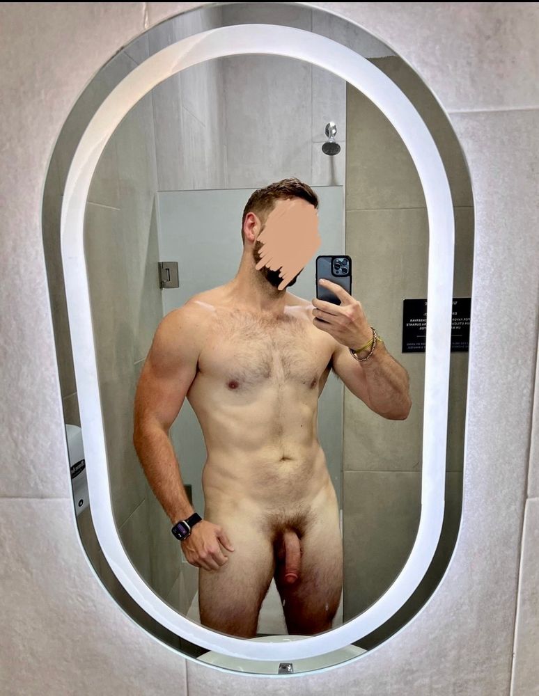 Standing naked reflected in an ocular mirror with a light going around it
