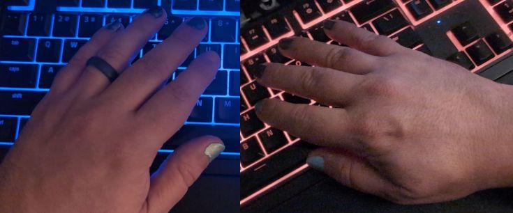 Hands with shoddy nail polish resting on a backlit RGB keyboard.