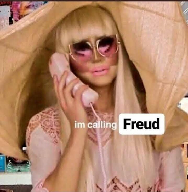 Trixie Mattel with a phone wearing a hat