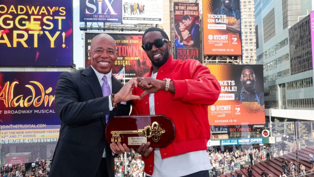 Eric Adams and Diddy posing together in Times Square with the Key to the City.