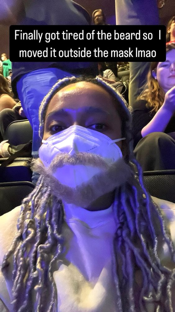 A photo of me towards the end of the night with my Kingston beard a fixed to the outside of my mask with a caption on screen that says, “Finally got tired of the beard so I moved it outside the mask lmao”