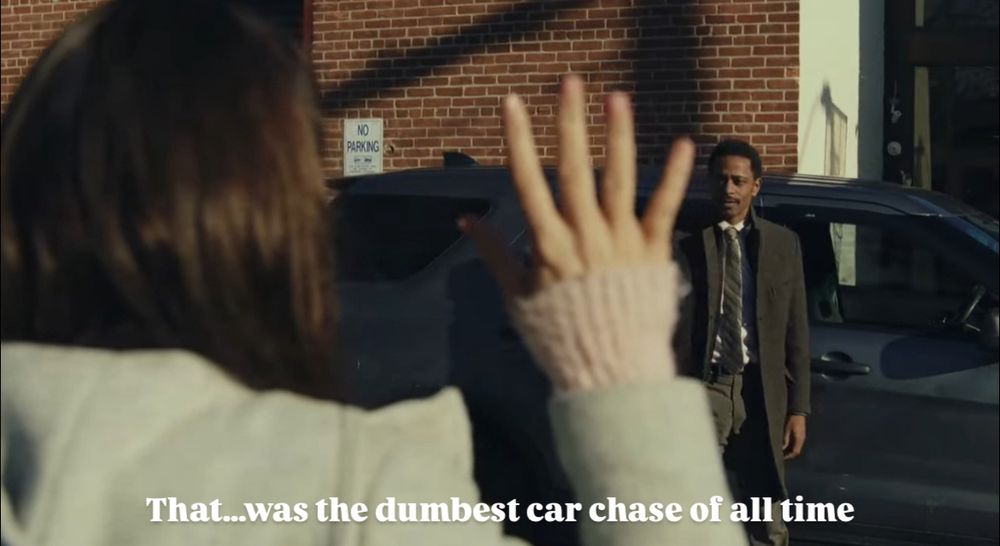Screenshot from Knives Out of Marta with her hands raised while the detective says “That… was the dumbest car chase of all time.”