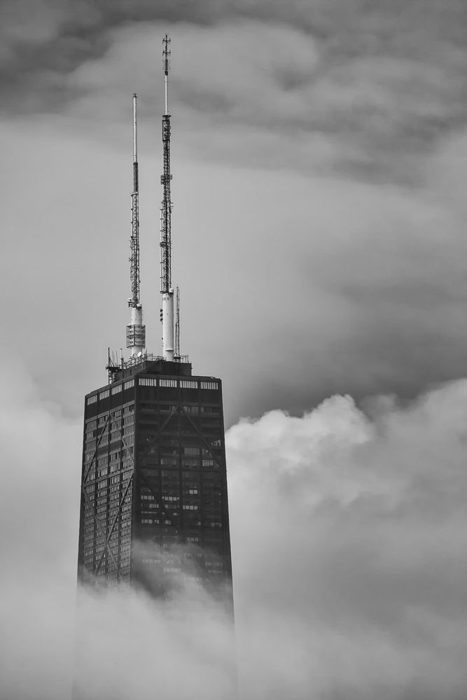 The John Hancock building in Chicago - the top third of the building in the clouds.