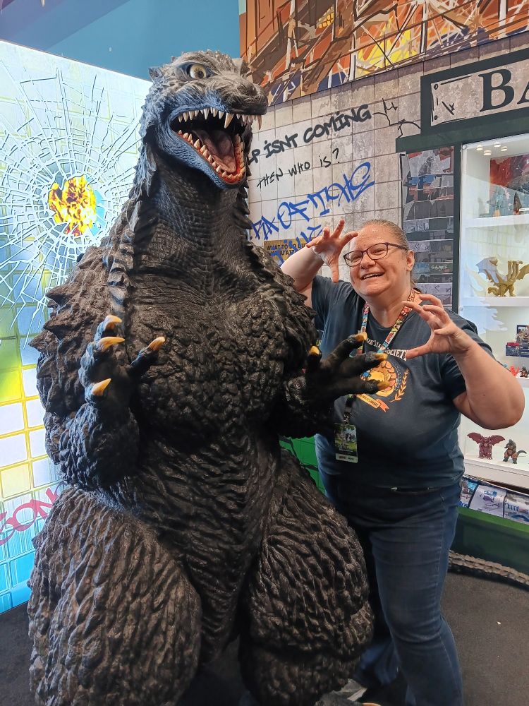 Jamie standing next to Godzilla. She's going for a scary pose. It isn't working.
