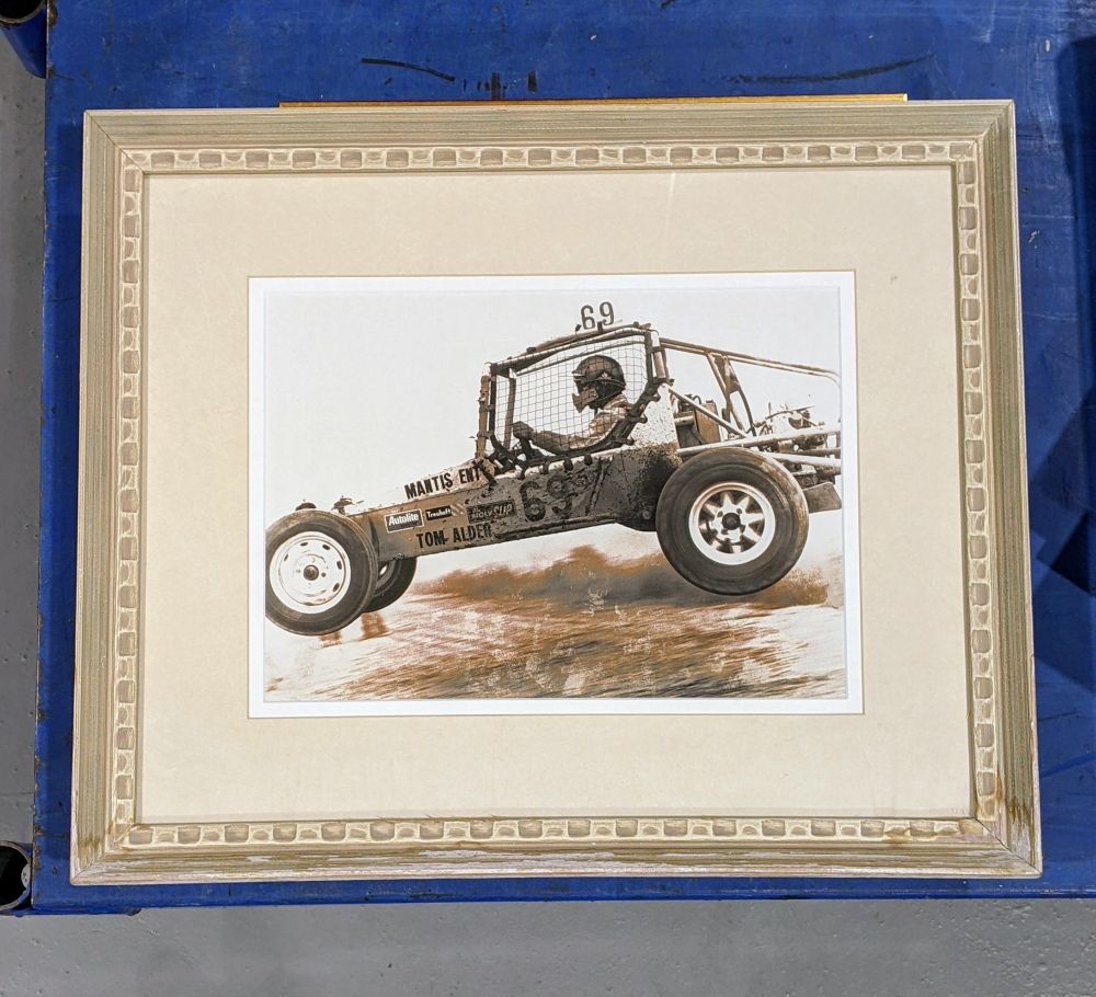 Framed photo of a jumping off-road racecar, numbered #69