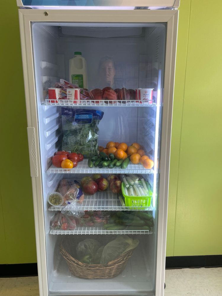 Fridge in the Pediatric Associates pantry filled with fresh veggies and fruits. 