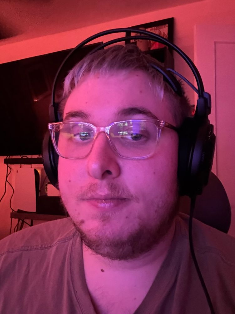 Me in light purple and orange lighting with my headphones on 