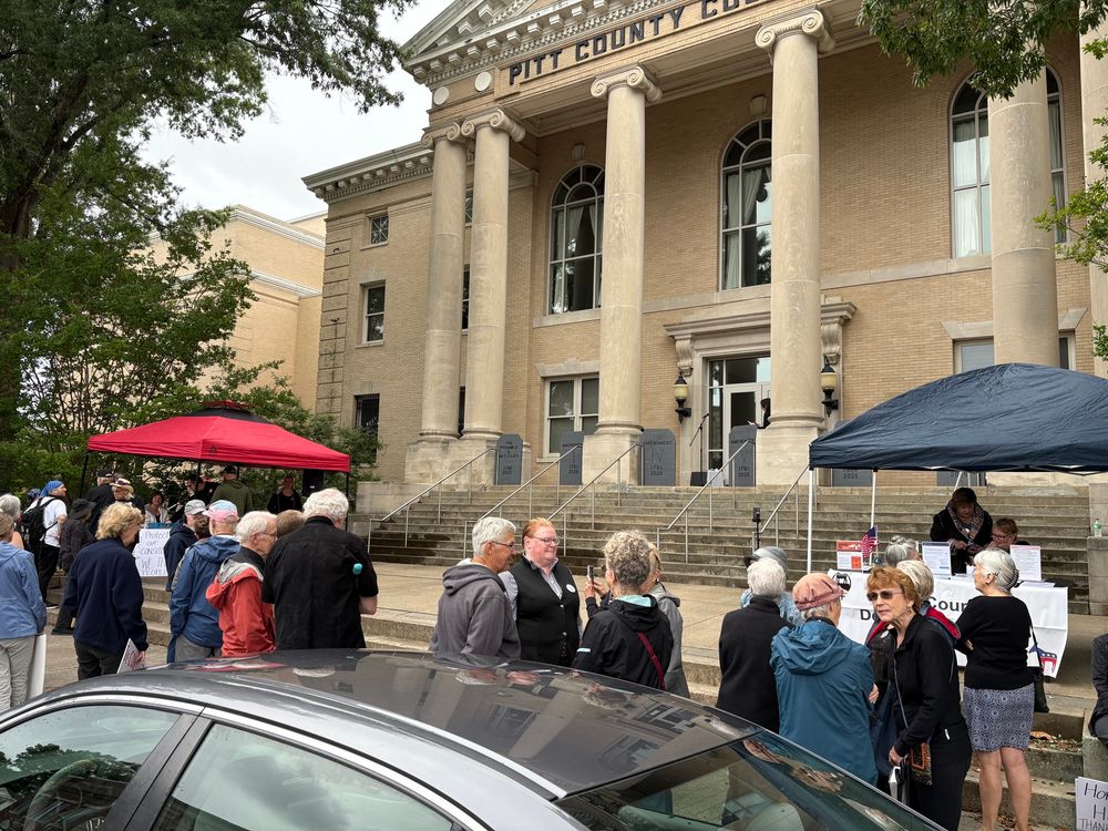 People waiting for the service to start outside the courthouse.