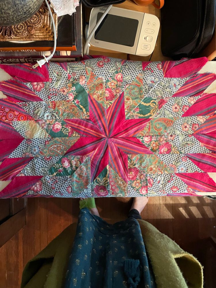 Unfinished star quilt in reds and greens.