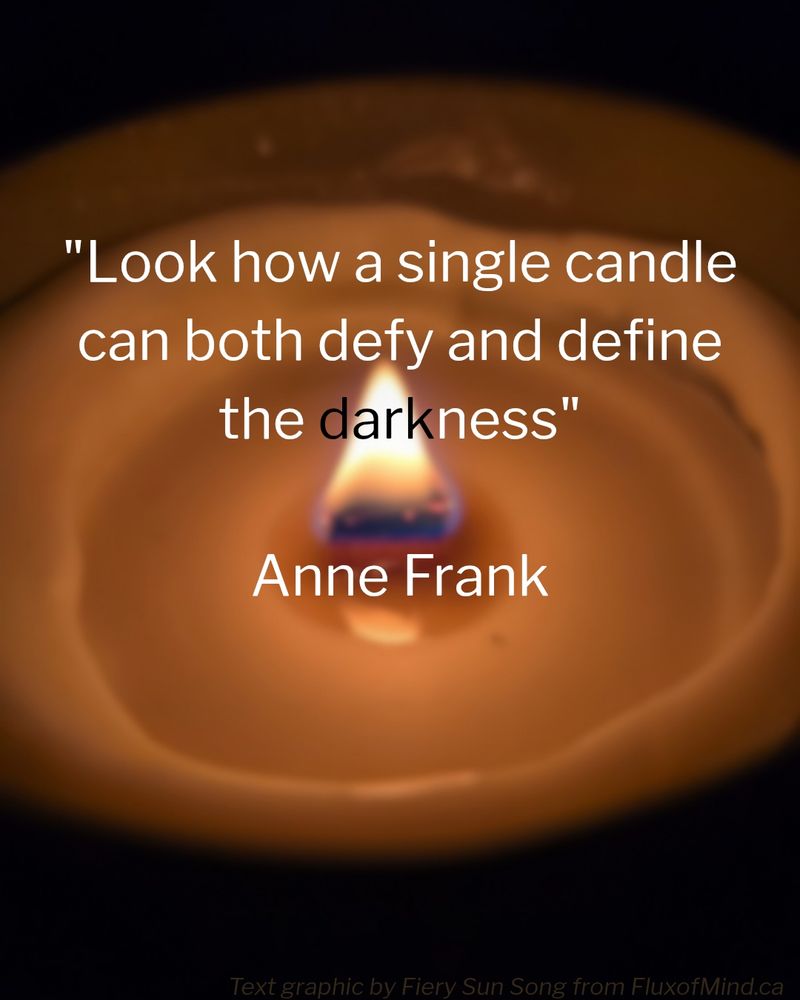 A macrophoto I took of the face of a wide, partially melted, white woodwick candle. The candle is lit and juxtaposed on a dark background. In the foreground is a quotation in white text. It reads: "Look how a single candle can both defy and define the darkness." -Anne Frank. 

The word 'dark' (from darkness) is centred over the flame, and is the only word in black font.

the faint brown text at the bottom states that this text graphic was made by Fiery Sun Song from Fluxofmind.ca