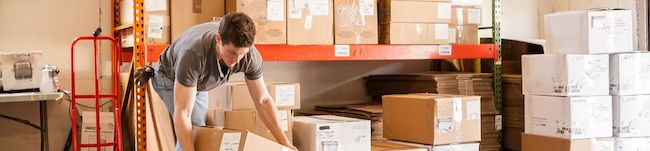 Photo from ShipDudes website of a male in a fulfillment warehouse