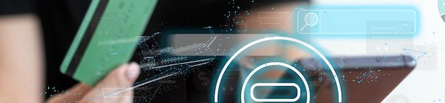 Person holding a credit card next to a smartphone in an abstract looking photo