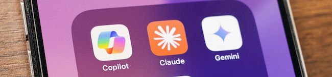 Icons for Copilot, Claude, and Gemini on a smartphone screen